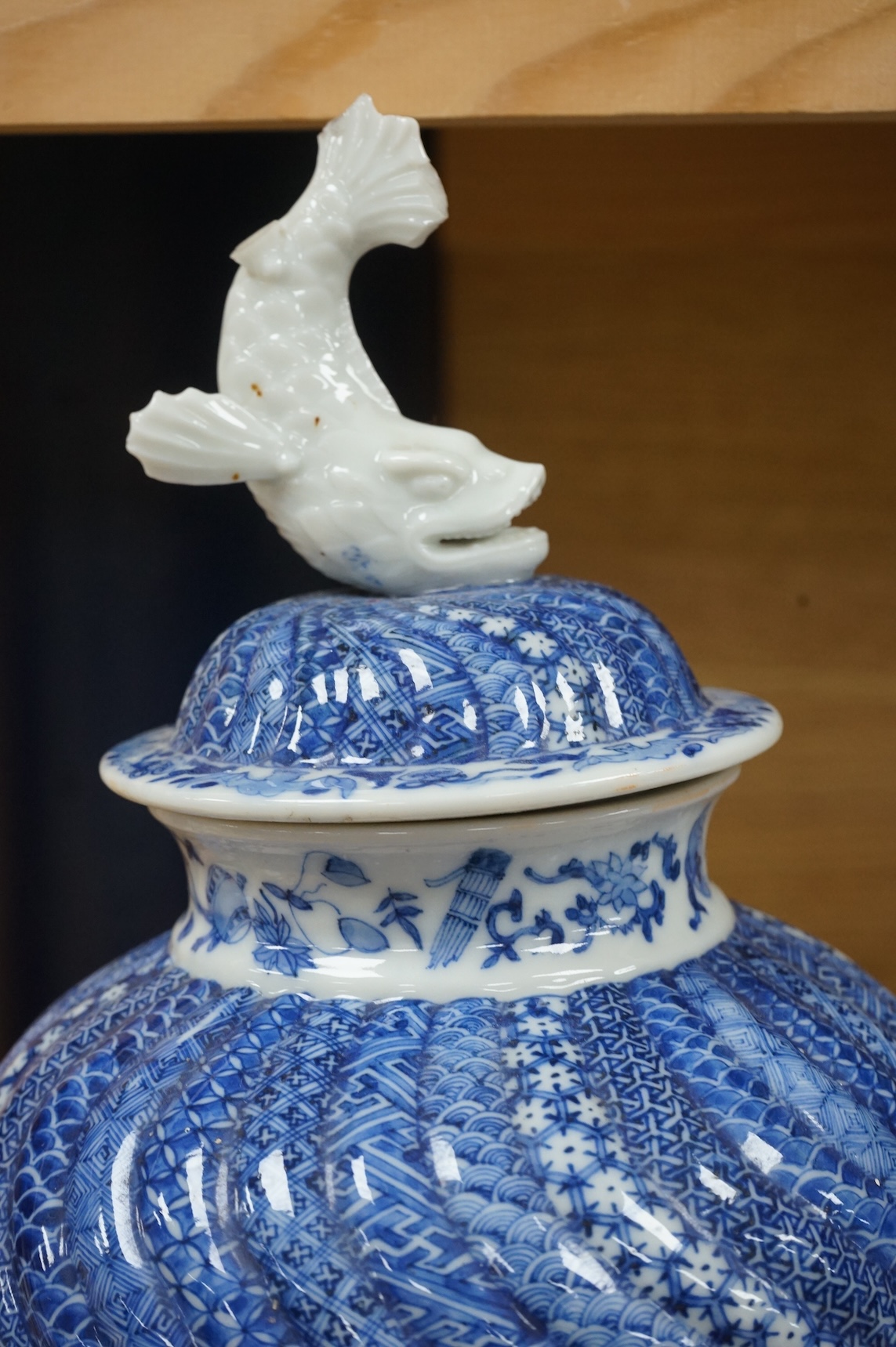 A Japanese blue and white water jar and cover, with fish knop, Meiji period, 31cm high